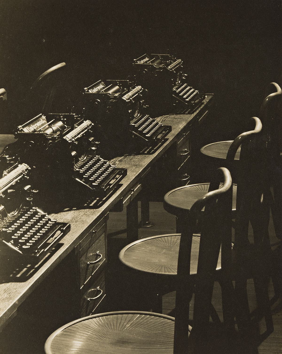 WENDELL MACRAE (1896-1980) Row of Empty Stools and Typewriters.